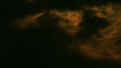 night sky and orange light on cloudscape because of moon