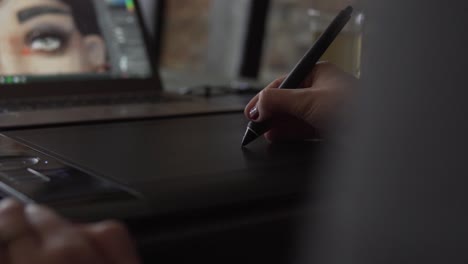 slow motion: female graphic designer working with tablet and digital pen