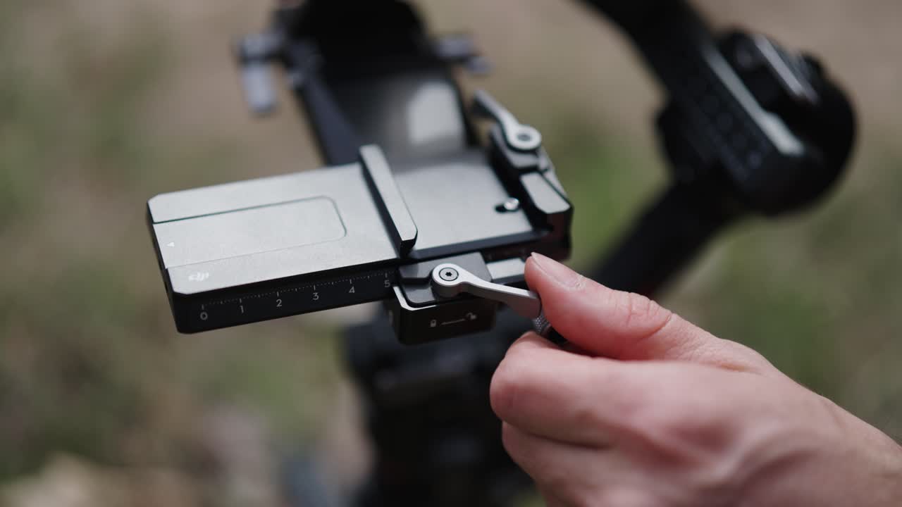 Person adjust fine tuning knob on tilt axis, electronic gimbal stabilizer