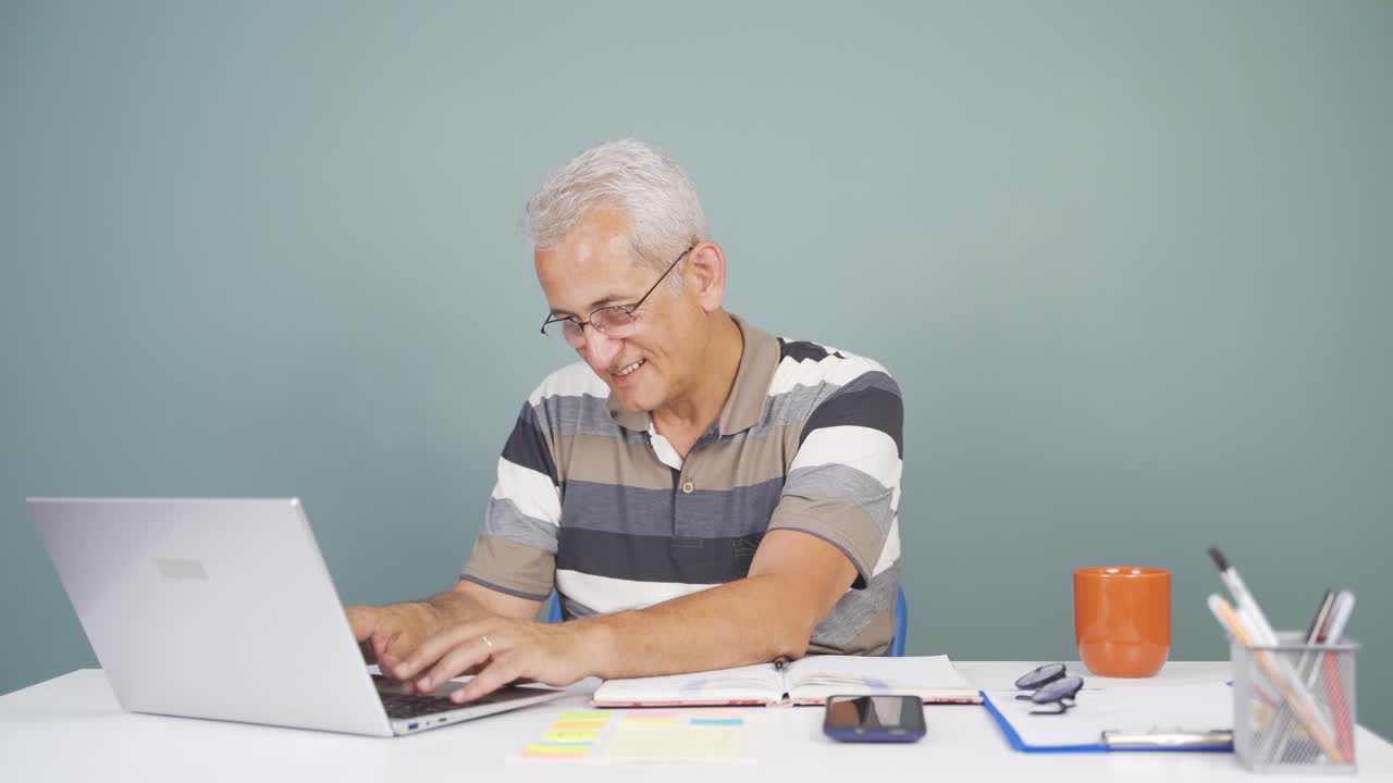 Man joyfully embracing laptop.