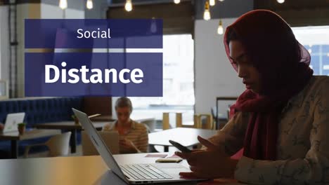 animation of a sign social distance over mixed race woman working in a coffee shop