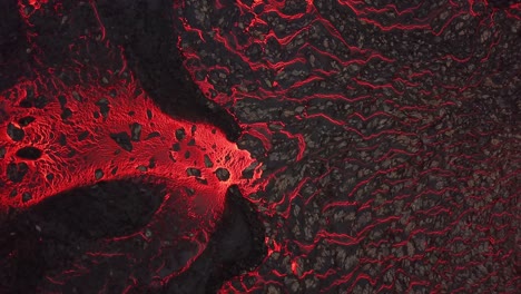 aerial view of a lava river flowing across meradalir valley, iceland, erupting out of fagradalsfjall volcano