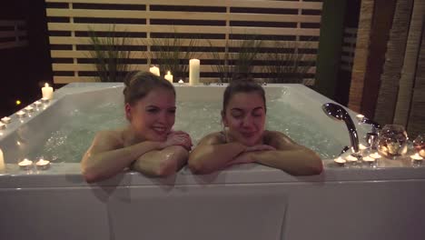 two women relaxing in a hot tub