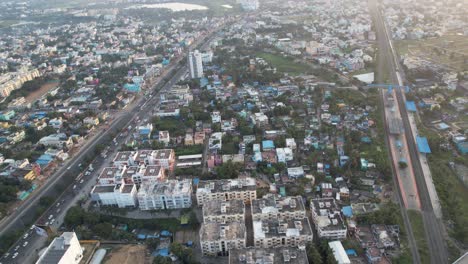 Chennai-City-India-Aerial-Shot-Of-Buildings-With-Traffic-And-Railway-Track-Nearby