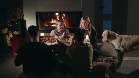 friends and family pizza night by the fireplace