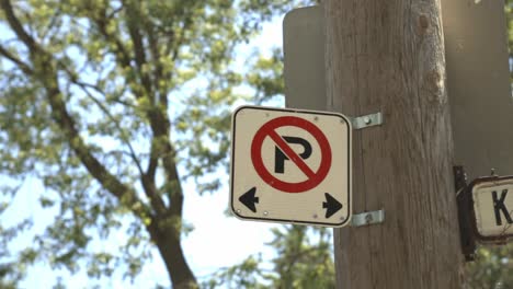 no parking sign screwed on a wooden post - close up