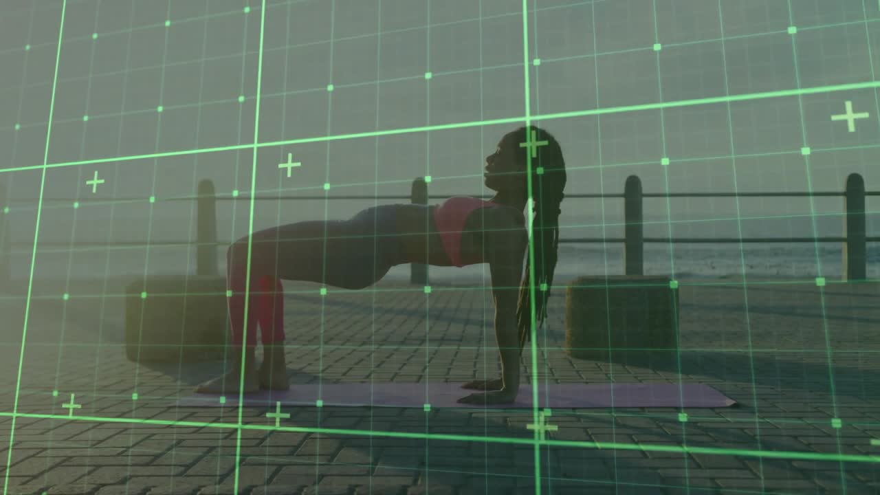 Woman unrolling yoga mat by seaside railing initiating grid scanning for reverse tabletop alignment