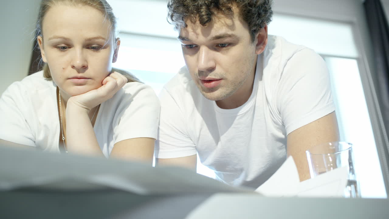 Two young architects working hard with plans
