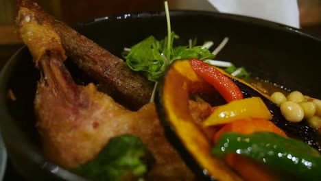 Close-up-of-soup-curry,-a-healthy-Japanese-food-with-variety-of-vegetables-and-meat-at-a-cafe