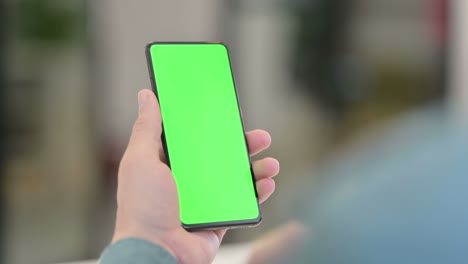 middle aged man using smartphone with chroma screen