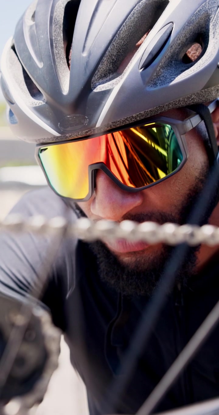 Cyclist Inspecting Bicycle Chain Outdoors