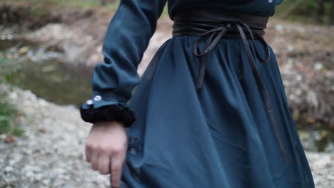 Whimsical-slow-motion-shot-of-a-woman-in-a-vintage-gothic-dress-dancing-and-spinning-in-the-forest