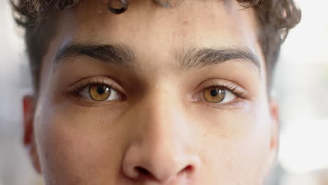 close-up of man's eyes, showing curiosity and focus in school setting, at office