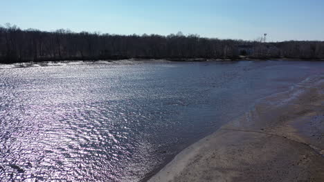 An-aerial-shot-over-a-creek-on-a-clear-day