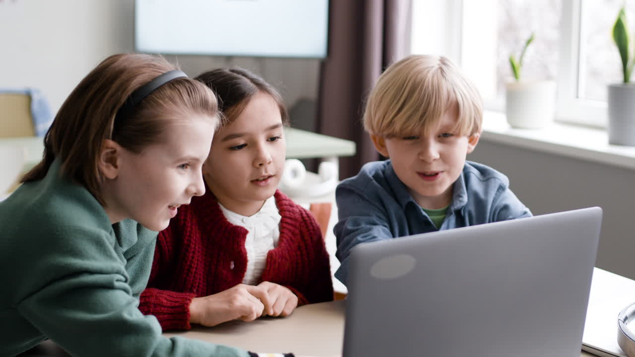 Children learning together on a laptop