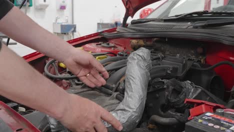 Person-checking-a-car-air-box-and-the-poor-repair-carried-out-using-tape