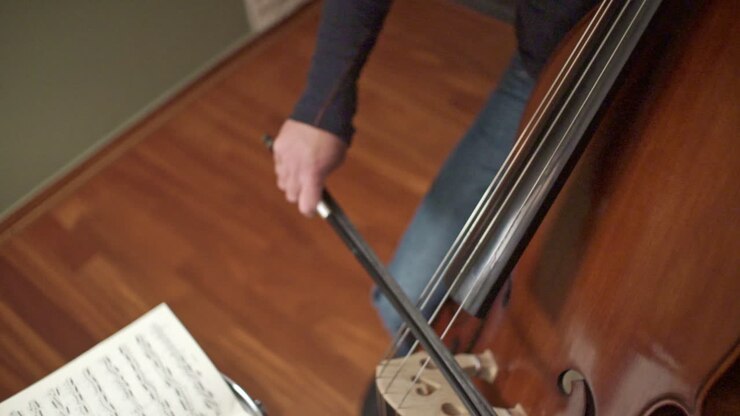 Footage Of A Musician Playing A Double Bass With A Bow