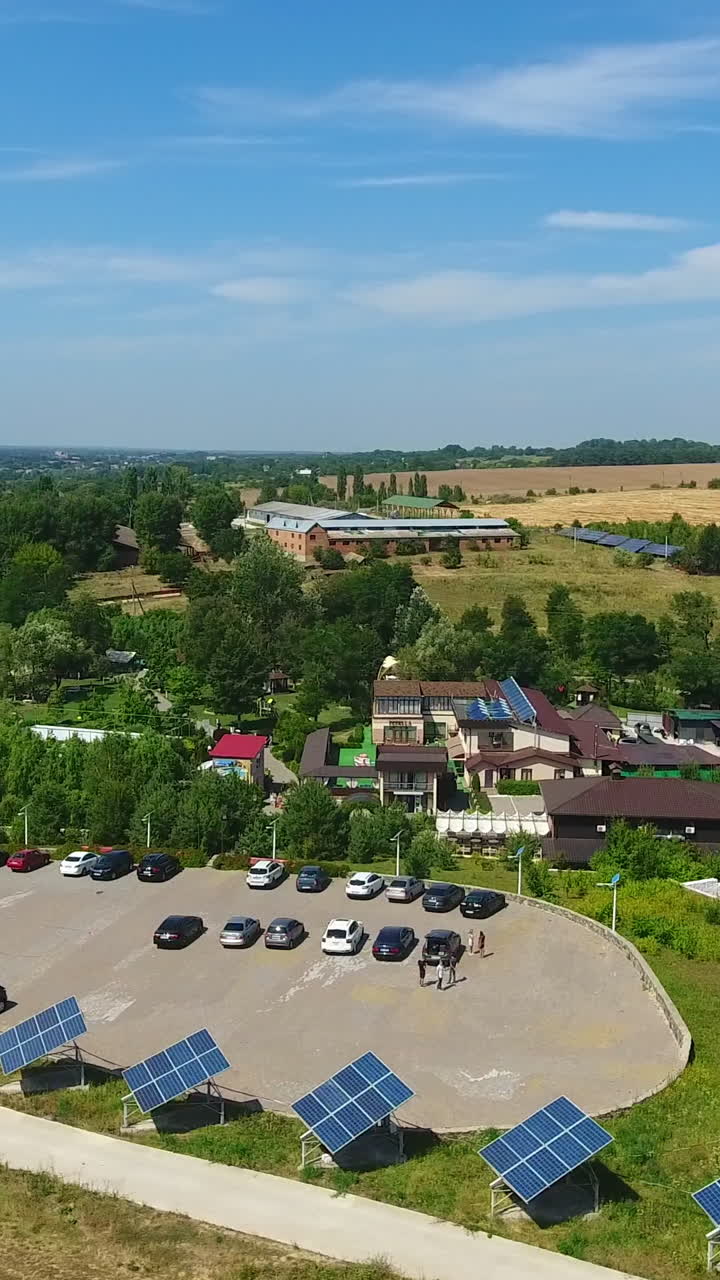 Well-organized rural territory for green tourism and rest. Houses and lawns equipped with solar panels. Spa resort area. View from above. Vertical video