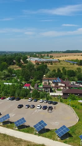 well-organized rural territory for green tourism and rest. houses and lawns equipped with solar panels. spa resort area. view from above. vertical video