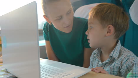 Mother-and-son-using-laptop-in-the-train