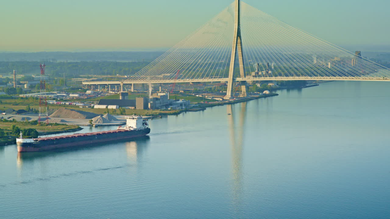 Drone shot of Great Lakes freighter on the Detroit river with international bridge in background