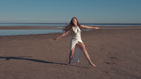 young woman dancing on beach
