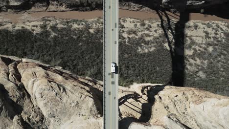 From-a-bird's-eye-perspective,-a-bridge-traversed-by-a-camper-truck,-Utah,-USA