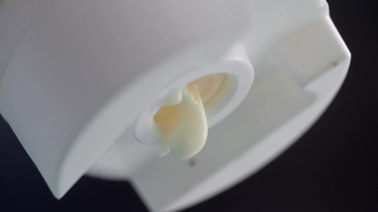 Cream Pouring from a Dispenser