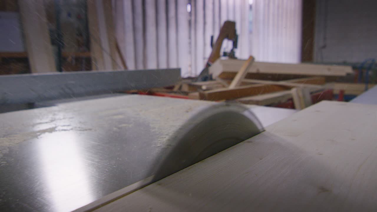 Macro close up of sawing boards from logs with industrial sawmill.