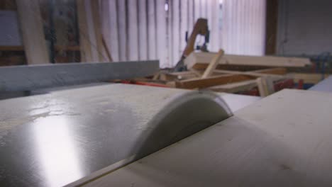 macro close up of sawing boards from logs with industrial sawmill.