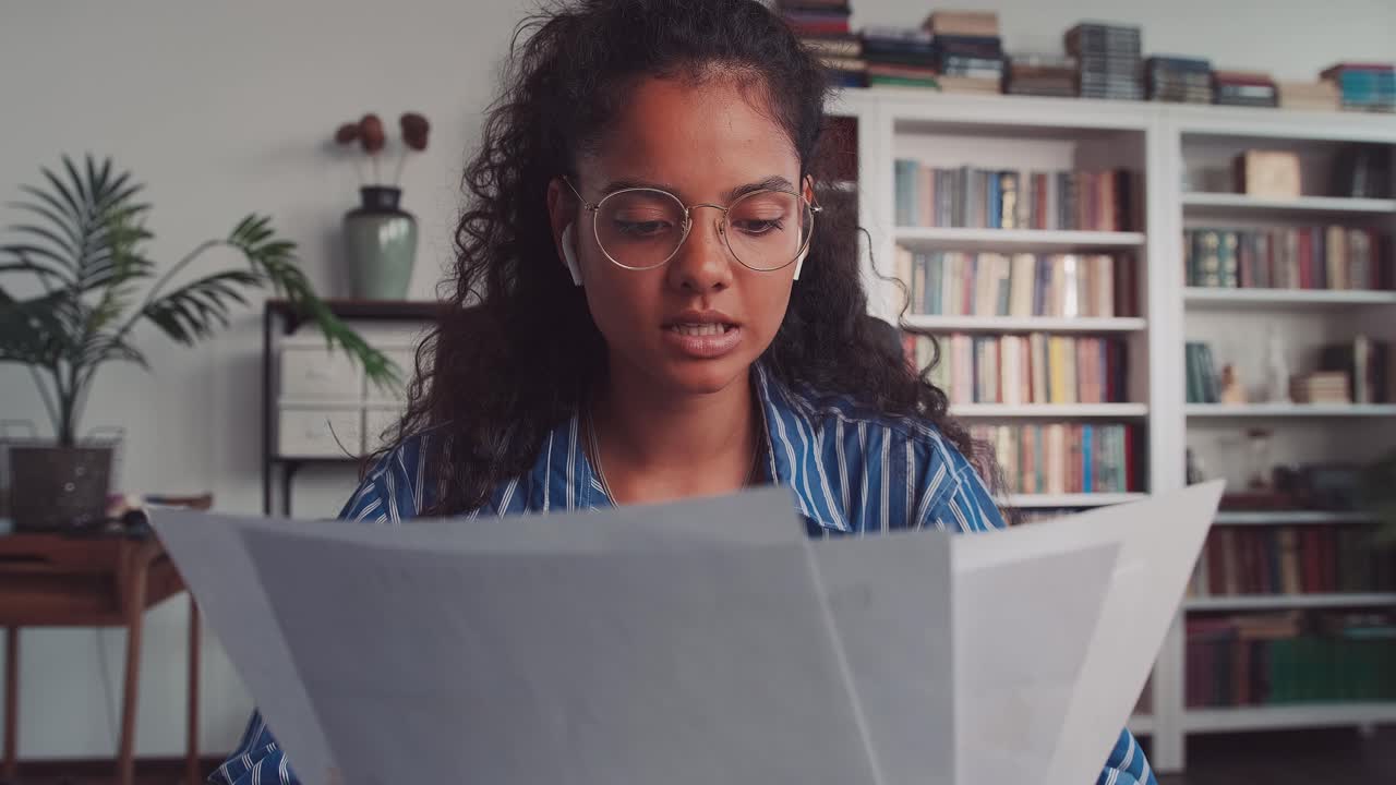 Webcam view of young indian woman sit at home speaking looking at camera