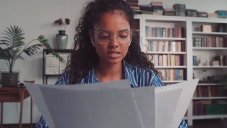 webcam view of young indian woman sit at home speaking looking at camera