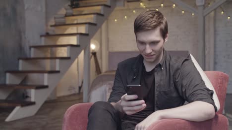 man using smartphone in a modern home