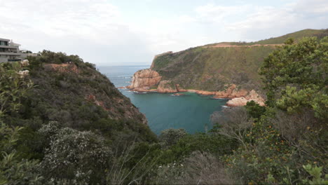 a beautiful summers day overlooking the knysna heads from a viewpoint with boats coming in and out of the indian ocean