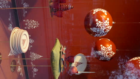 Vertical-shot-of-Christmas-balls-and-other-decorations-displayed-at-store