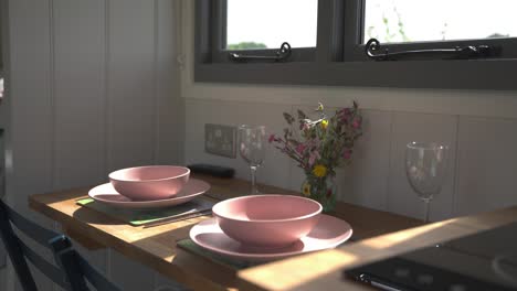 small glamping barn dining set up prepared for guests in rustic english getaway cottage