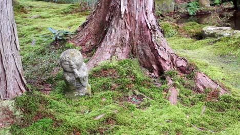 serene stone jizo statue in a mossy japanese garden