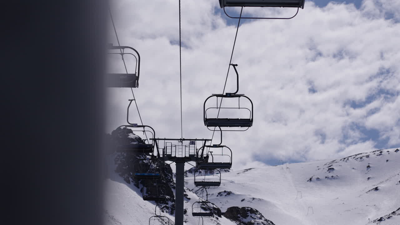 bokeh toma de sillas de ascensor de esquí, ningún movimiento, cielo cneter en las montañas nevadas de argentina bariloche, copia espacio, cielo nublado