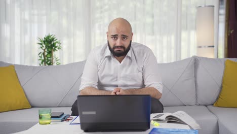 home office worker man looking emotional at camera.