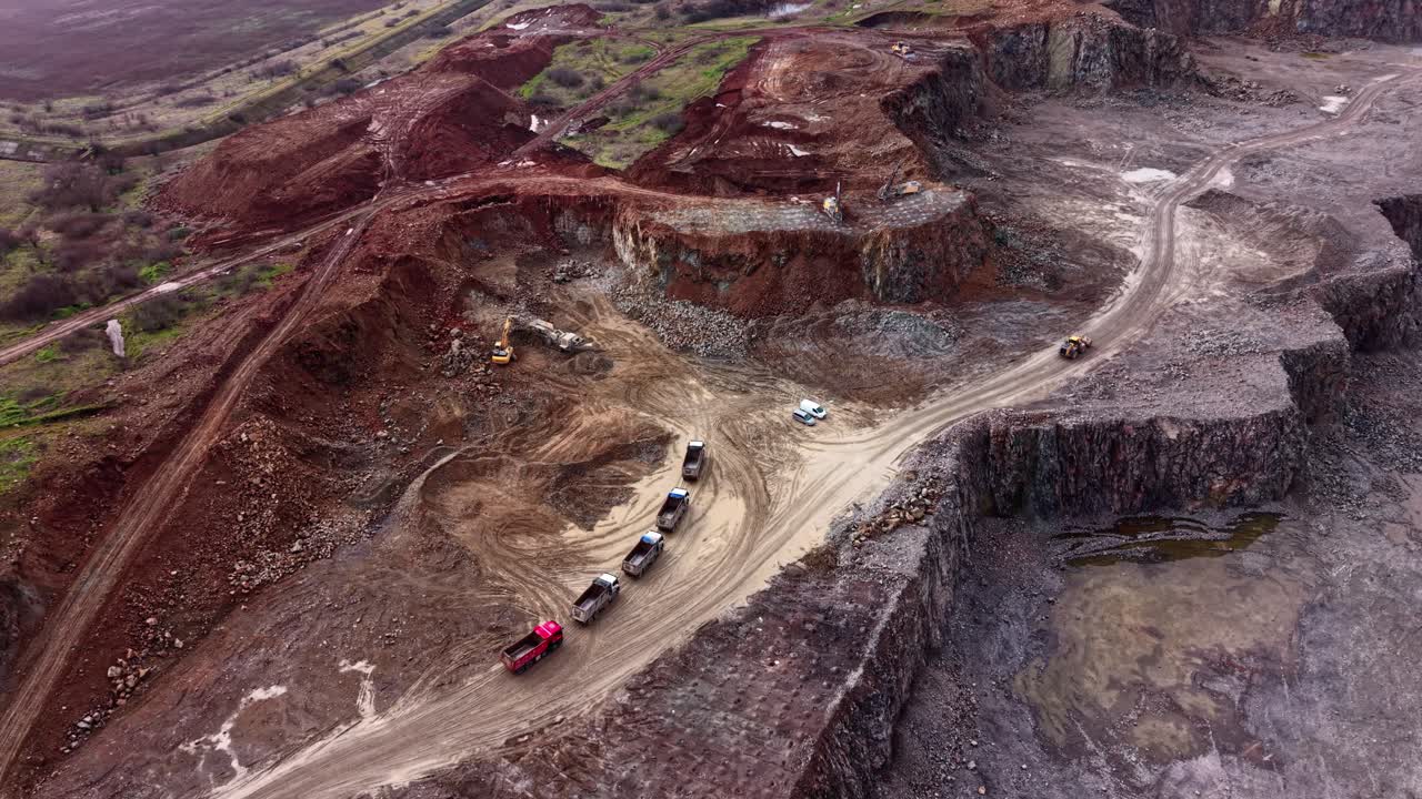 Granite quarry site with trucks and heavy machinery working