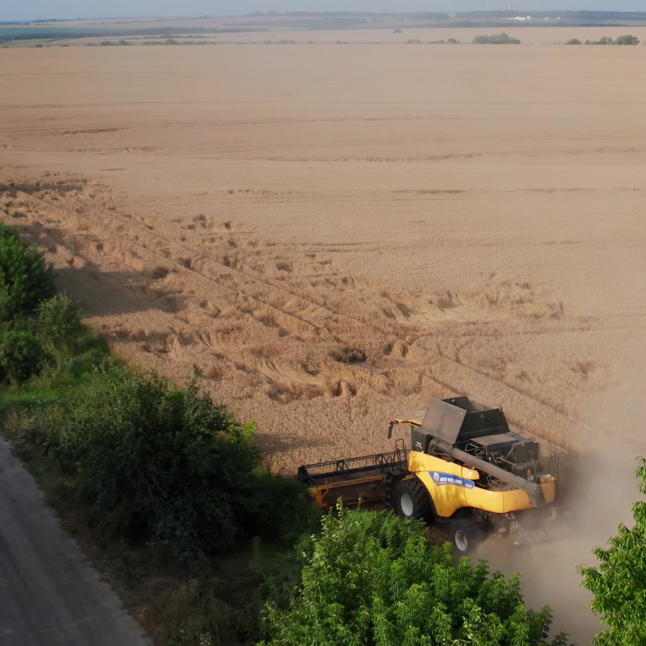 Yellow wheat landscapes. Aerial view of big combine working on the field