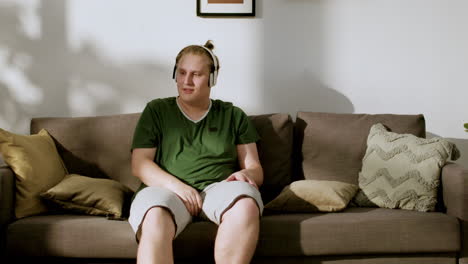 guy with headphones at home