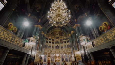 tilt ultra wide shot interior of a big cathedral, golden chandelier middle of the shot, gothic church