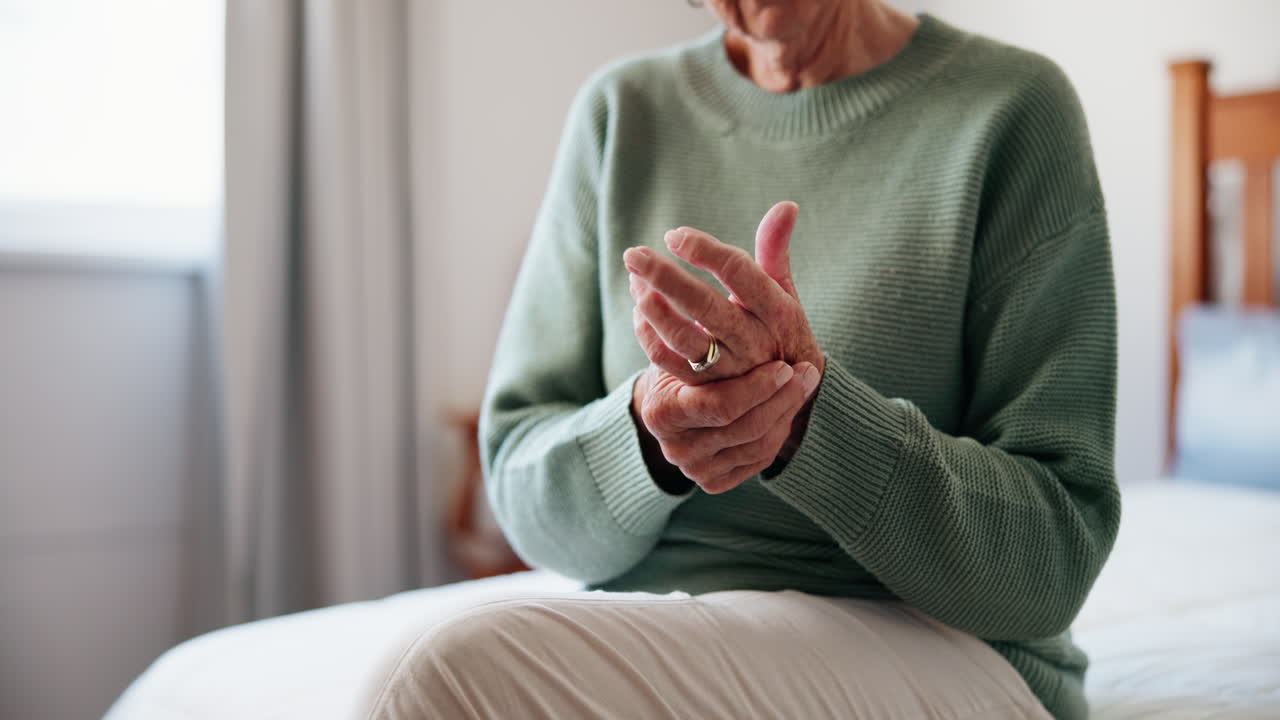 Older woman experiencing hand and joint pain