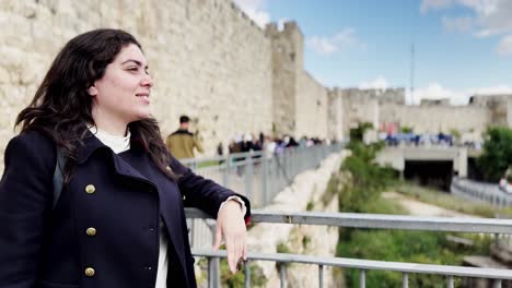serene woman by jerusalem's ancient stone wall