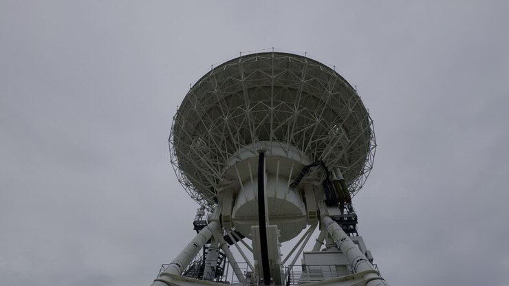 Exploring Japan’s Iwate Radio Telescope The Iwate radio telescope, set in a peaceful landscape, contrasts with the cloudy Japanese sky