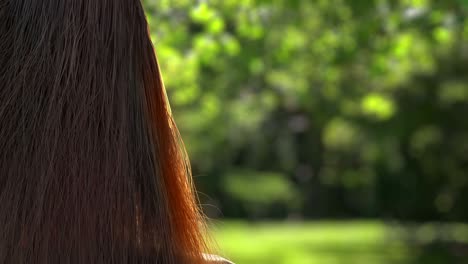 fluttering hair of a girl on the background of the forest.