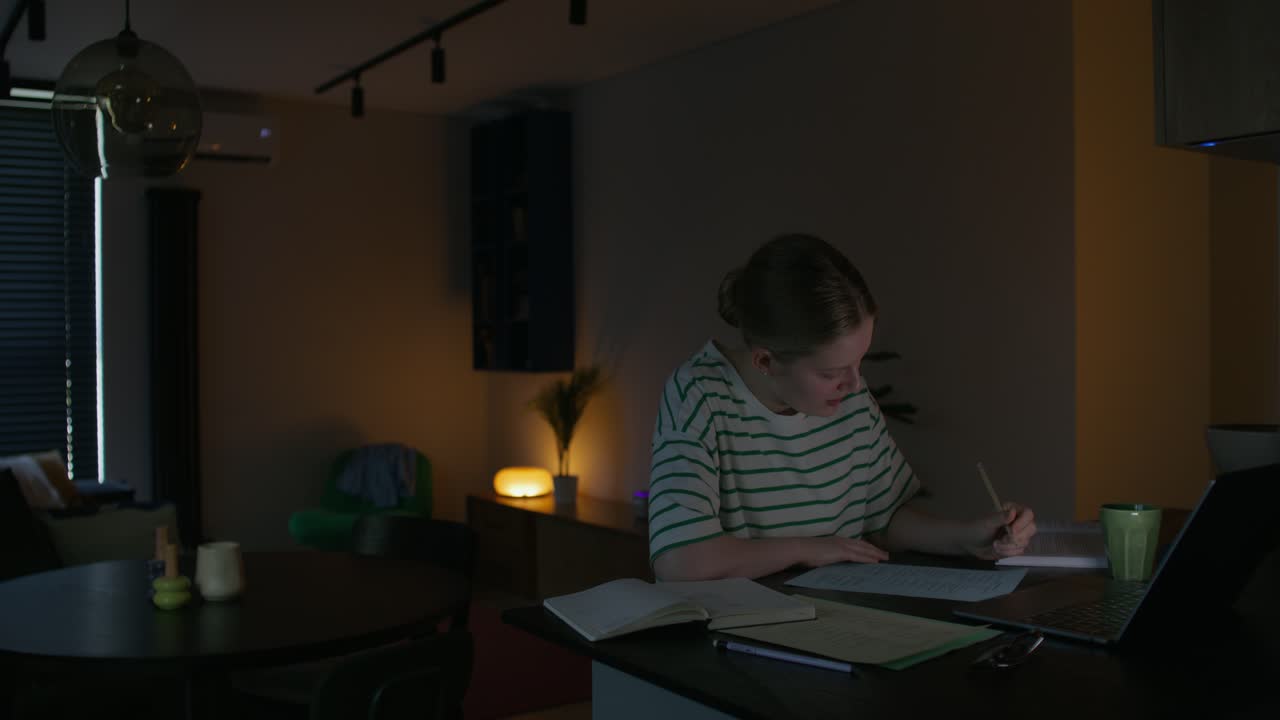 Teenager Studying at Home at Night