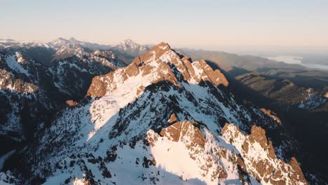 una foto de un dron de una alta montaña en las montañas olímpicas tomada desde las afueras del parque nacional al atardecer