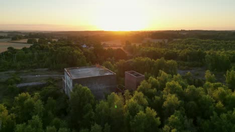 Drone-shoot-flying-backwards-showing-the-sunrise-over-an-abandoned-coal-mining-shaft-in-Kent-UK